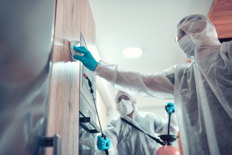 Experts Sanitizing Apartment Kitchen