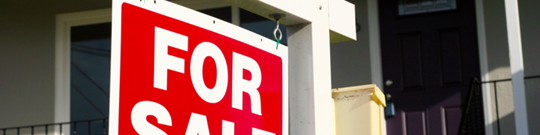 House listed for sale sign